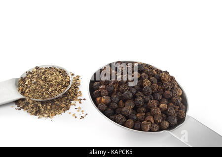 Black Peppercorns and Ground Pepper on white background Stock Photo