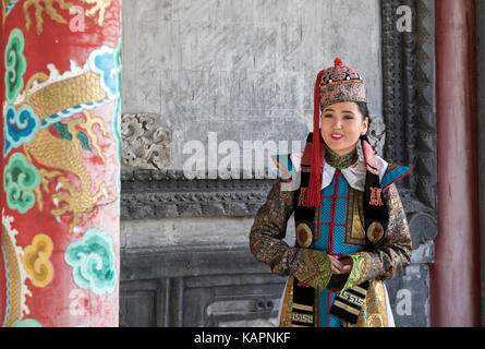 mongolian woman in traditional outfit near old Temple in Ulaanbaatar ...