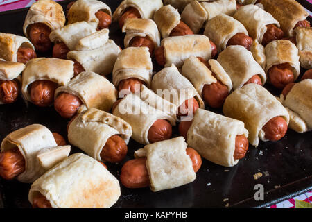 Homemade mini hot dogs (sausage dough) on the tray Stock Photo