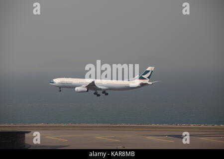 the plane is landing in Hong Kong international airport Stock Photo