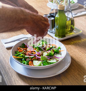 Healthy eating,Evening meal including five-a-day,Salad with fresh vegetable ingredients - lettuce,carrots,avocado pear,onions,tomotoes,cucumbers Stock Photo