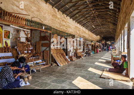 BAGAN, MYANMAR - JANUARY 23, 2016 : Sellers produce and offer souvenirs at the entry of  Shwezigon Pagoda in Nyaung Oo, Bagan, Myanmar Stock Photo