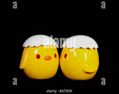 Two Vivid Yellow Kissing Baby Chicks Ceramic Doll on Black Background Stock Photo