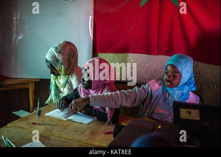 Inside the school with pupils and teacher in Khamila village, Morocco Stock Photo