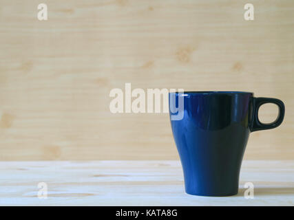 Front view of navy blue mug on the light color wooden table Stock Photo