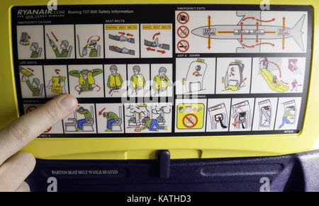 (FILE) An archive photo dated 04 April 2011 shows a man pointing to the safety information in a Ryanair airplane in Weeze, Germany. Photo: Caroline Seidel | usage worldwide