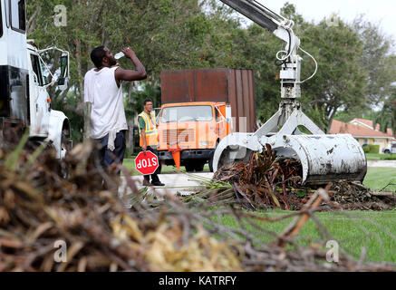 Wellington, Florida, USA. 27th Sep, 2017. William Bridges, Moycock, NC takes a drink of water as he takes a break from cleaning up Hurricane Irma debris on Fallview Way in Wellington, Florida on September 27, 2017. Credit: Allen Eyestone/The Palm Beach Post/ZUMA Wire/Alamy Live News Stock Photo