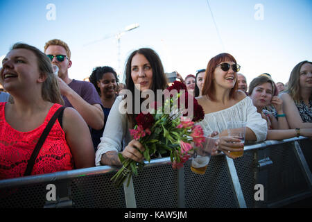 Norwegian music fans attend a live concert with the American gypsy punk band Gogol Bordello who performs at Sukkerbiten in Oslo. Norway, 20/07 2016. Stock Photo