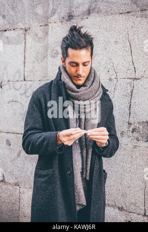 Young man smoking // Street style in Madrid Stock Photo