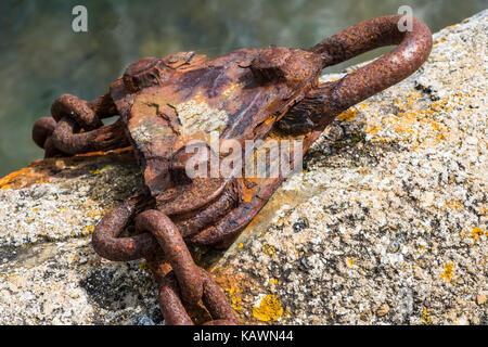 Close-up Detail of a Rusting Mooring Chain on a Wall. Stock Photo