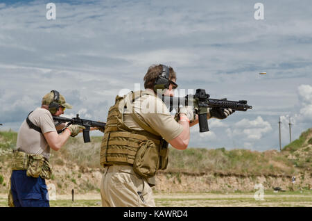 Men shooting outdoors Stock Photo