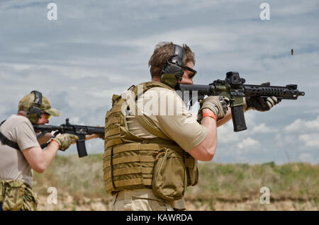 Men shooting outdoors Stock Photo