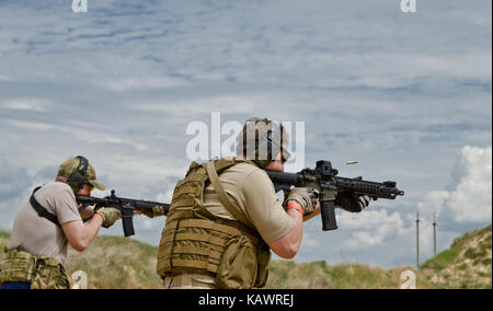 Men shooting outdoors Stock Photo