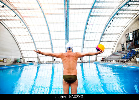 Water polo player in a swimming pool. Stock Photo