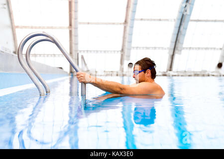 Man swimming in an indoor swimming pool. Stock Photo