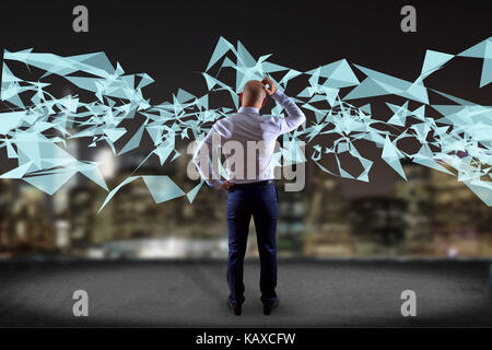 View of a Businessman in front of a wall with Abstract triangle displayed on a futuristic interface with line and points - Technology and connection c Stock Photo