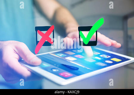 View of Hand drawn red and green tick icon going out a tablet interface of a man at the office - Business concept Stock Photo