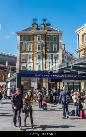 Great Northern Hotel against a blue sky, and people at the entrance to the London Underground tube station at Kings Cross and St Pancras. England, UK. Stock Photo