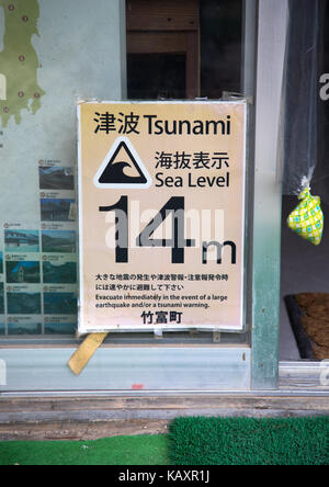 Billboard with the sea level for tsunami disaster prevention, Yaeyama Islands, Taketomi island, Japan Stock Photo