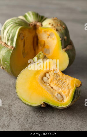 Fresh heirloom green Turban squash and a slice Stock Photo