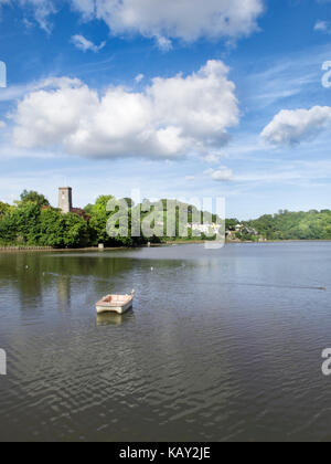 The Mill Pond at Stoke Gabriel, Devon, UK with the church of St. Mary and St. Gabriel in the background on a sunny summer's day with fluffy clouds. Stock Photo