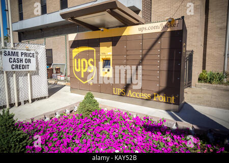 A UPS Access Point pick-up station in outside of a gas station in the Greenpoint neighborhood of New York on Saturday, September 23, 2017. The lockers enable customers, who work and do not have doorman or another party, to receive their purchase in a secure location. Amazon has had a similar network of lockers for several years. (© Richard B. Levine) Stock Photo