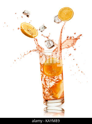 glass full of orange drink with orange slices and ice cubes falling and splashing, on white background Stock Photo