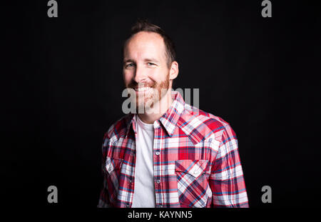 Portrait of a young successful man over black background Stock Photo
