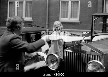1970s wedding party hired wedding car being decorated with white toilet loo roll of paper.  London UK 70s HOMER SYKES Stock Photo