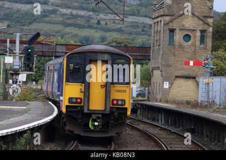 Class 150 Sprinter diesel multiple unit train in Northern livery leaving Carnforth railway station with a passenger service to Leeds. Stock Photo