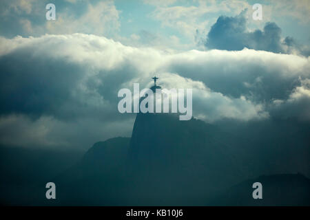 Christ the Redeemer in the clouds atop Corcovado, seen from Niteroi City Park, Niteroi, Rio de Janeiro, Brazil, South America
