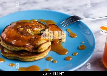 Stack of two homemeade gluten free pancakes served with peach jam on sky blue plate Stock Photo