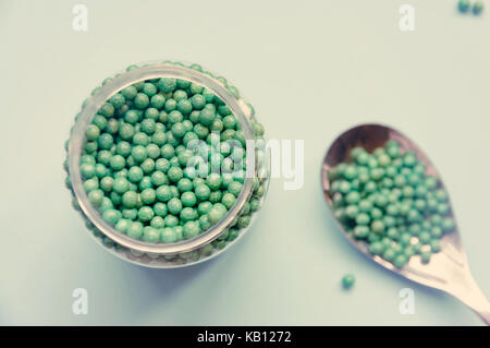 Natural vegetable biologically active additive. In the form of small green balls. Natural medicines from Asia Stock Photo