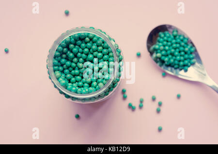 Natural vegetable biologically active additive. In the form of small green balls. Natural medicines from Asia Stock Photo
