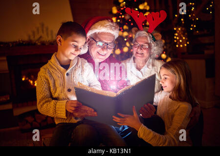 Christmas magic book and happy family Stock Photo