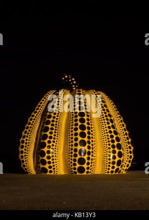 Yellow pumpkin by yayoi kusama on pier at night, Seto Inland Sea, Naoshima, Japan Stock Photo