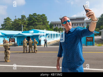 Tourist taking a selfie in the joint security area on the border between the two korea, North Hwanghae Province, Panmunjom, South Korea Stock Photo