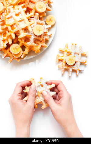 Female hands holding the fresh homemade waffles Stock Photo