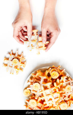 Female hands holding the fresh homemade waffles Stock Photo