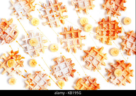 Many small waffles with banana and honey on the white table Stock Photo