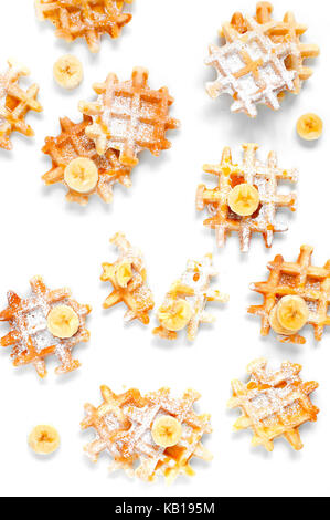 Many small waffles with banana and honey on the white table Stock Photo