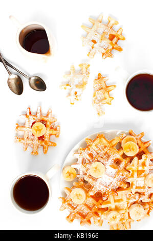 Fresh homemade waffles and two cups of tea on the white table Stock Photo