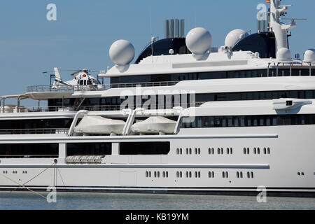 Luxury yacht with private helicopter, moored on harbor Stock Photo