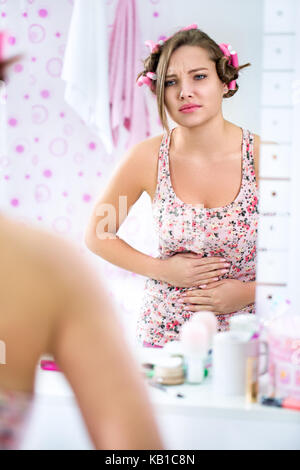 Young teen girl in bathroom having period cramps Stock Photo - Alamy