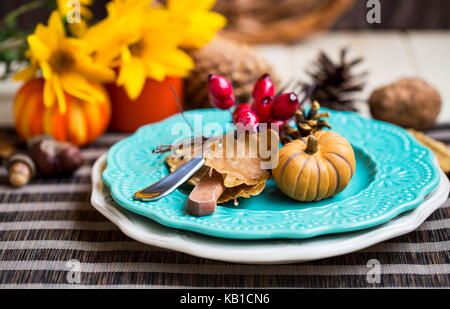 Thanksgiving setting table decoration with cutlery, plates and autumn decorations Stock Photo