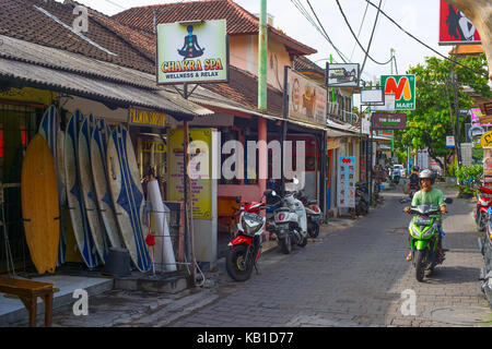 KUTA, BALI ISLAND, INDONESIA - JAN 28, 2017: Typical street with local touristic shops in Kuta. Kuta is the most famous and crowded tourist destinatio Stock Photo