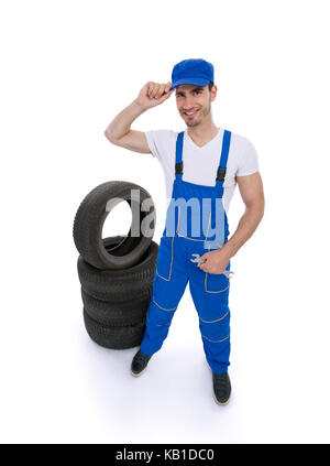 Male mechanic holding a wrench and looking at camera isolated on white background Stock Photo