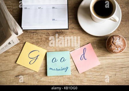 Good morning on work cup of coffee on wooden desk Stock Photo