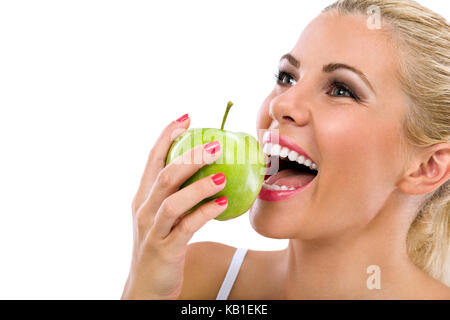 woman with healthy teeth eat green apple Stock Photo