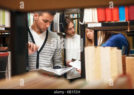 Students in library choosing books Stock Photo